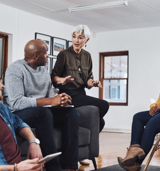 Office, discussion and business people at creative workshop for project management, planning and development. Relax, men and women in lounge for meeting, proposal or ideas for design company growth.